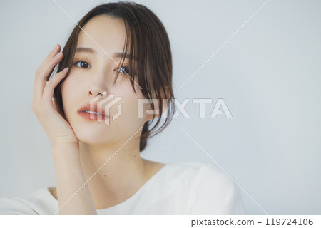 Young woman by the window 119724106