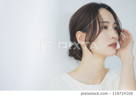 Young woman by the window Young woman by the window 119724108