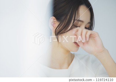 Young woman by the window 119724110