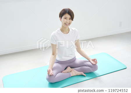 中年婦女做坐禪瑜伽，看著相機 119724552