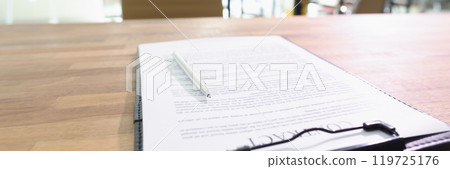 Contract documents and pen lie on table in business office Contract documents and pen lie on table in business office 119725176