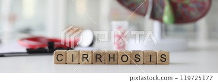 Word Cirrhosis made of wooden blocks against model of liver 119725177