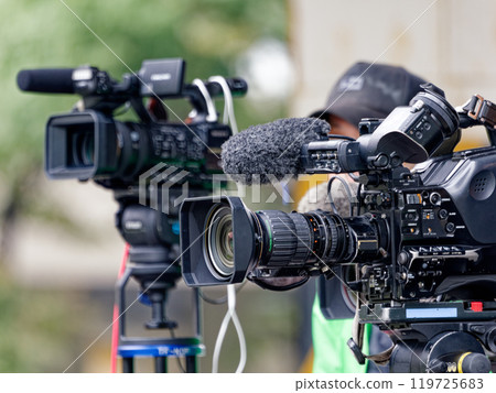 A TV cameraman working in the city 119725683