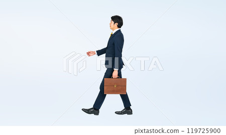 Full body photo of a walking young male business person 119725900