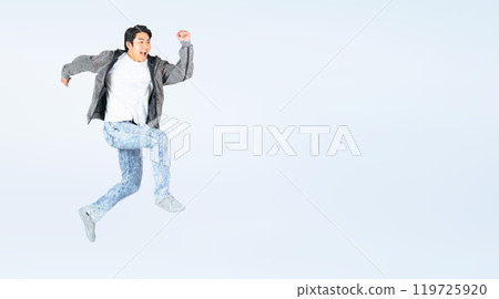Full body photo of a man in casual clothing jumping 119725920