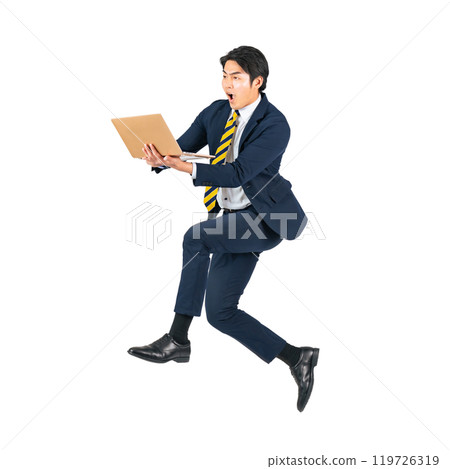 A young male business person jumping while using a laptop computer. Full body with transparent background precisely cut out by hand. A young male business person jumping while using a laptop computer. Full body with transparent background precisely cut out by hand. 119726319