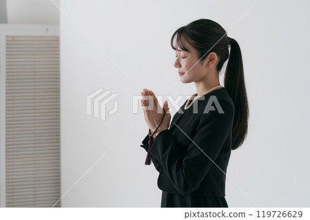 一個穿著喪服、雙手合十的女人的側影 一個穿著喪服、雙手合十的女人的側影 119726629