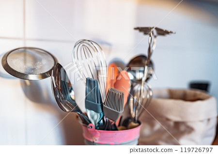 Kitchen utensils or cooking tools in iron decorative bucket, on kitchen wooden surface. Kitchen utensils collection Kitchen utensils or cooking tools in iron decorative bucket, on kitchen wooden surface. Kitchen utensils collection 119726797