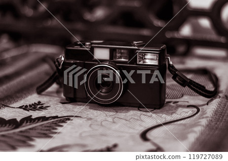 Vintage Film Camera on Ornate Table Surface 119727089