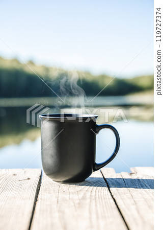 Cup of hot drink on nature background. Morning in the forest in nature with a hot drink 119727374