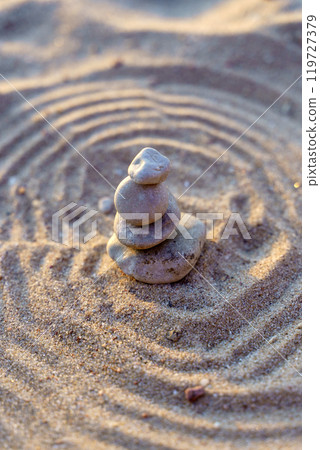 Zen stones background. Pyramid of stones on the background of sunset on the sea beach. Relax, balance, calm, concept. 119727379