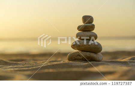 Zen stones background. Pyramid of stones on the background of sunset on the sea beach. Relax, balance, calm, concept. 119727387