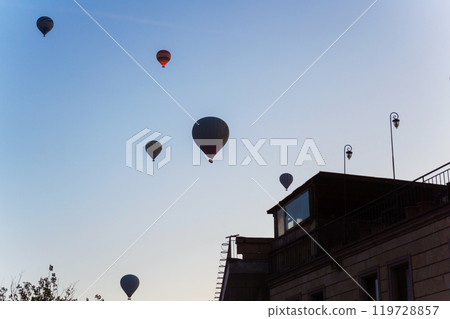 Colorful hot air balloons fly gracefully over a vibrant skyline in valley Cappadocia Turkey Colorful hot air balloons fly gracefully over a vibrant skyline in valley Cappadocia Turkey 119728857