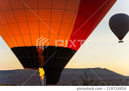 Three colorful hot air balloons are gracefully flying high in the sky Three colorful hot air balloons are gracefully flying high in the sky 119728859