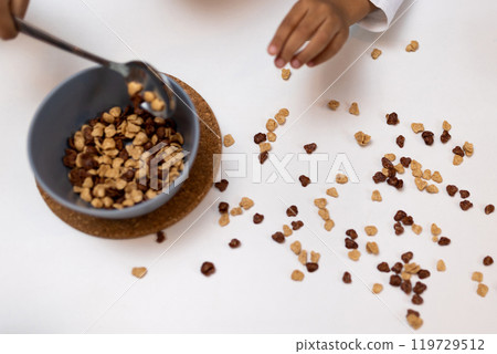 Close up picture of a table with a spilled cereals Close up picture of a table with a spilled cereals 119729512