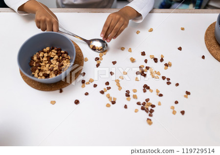 Close up picture of a table with a spilled cereals Close up picture of a table with a spilled cereals 119729514