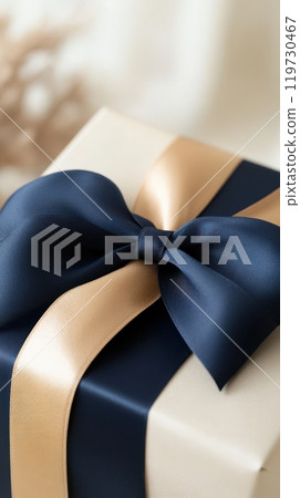 Elegant Blue and Gold Ribbons Adorning a Luxurious Gift Box for or Holiday 119730467