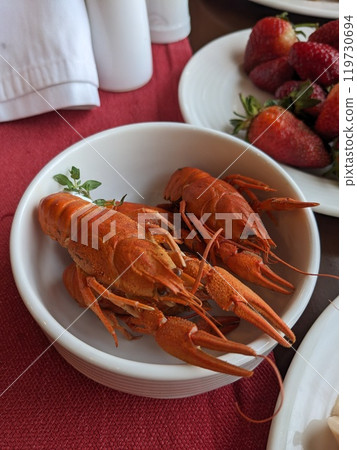 Boiled red crayfish in a plate served on the table Boiled red crayfish in a plate served on the table 119730694
