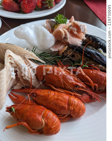 Boiled red crayfish in a plate served on the table Boiled red crayfish in a plate served on the table 119730695