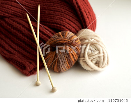 Colorful yarn and knitting needles and red knit Colorful yarn and knitting needles and red knit 119731043