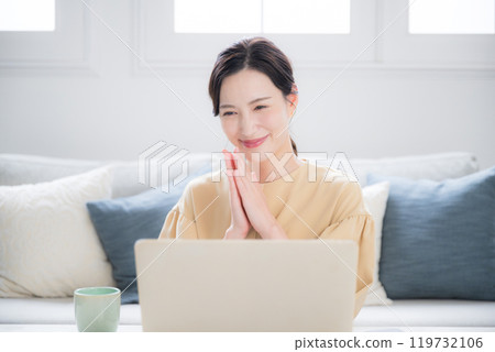當電腦前的一個可愛的女人看到網路或電腦螢幕上的銷售時,她會很高興並鼓掌。 當電腦前的一個可愛的女人看到網路或電腦螢幕上的銷售時,她會很高興並鼓掌。 119732106