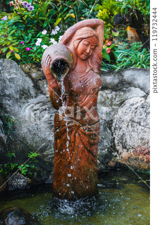 statue of woman with a jug in a fountain on a pagoda in Asia statue of woman with a jug in a fountain on a pagoda in Asia 119732444
