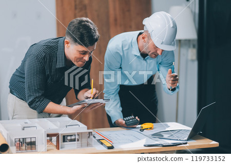 Team Engineers with draft plan of building on constructing site. Engineer work on site. engineer visit and inspection site engineer. Inspector engineer check and working on site. 119733152