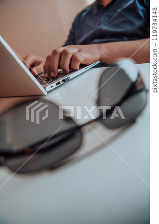 Close-up photo of a programmer typing on a laptop 119734148