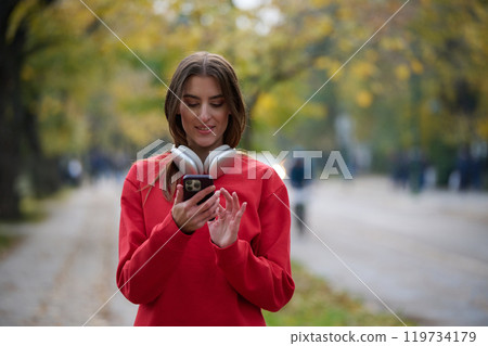 Athletic young woman taking a breath and relaxing after jogging and stretching. Woman Training and Workout Exercises On Street. Athletic young woman taking a breath and relaxing after jogging and stretching. Woman Training and Workout Exercises On Street. 119734179