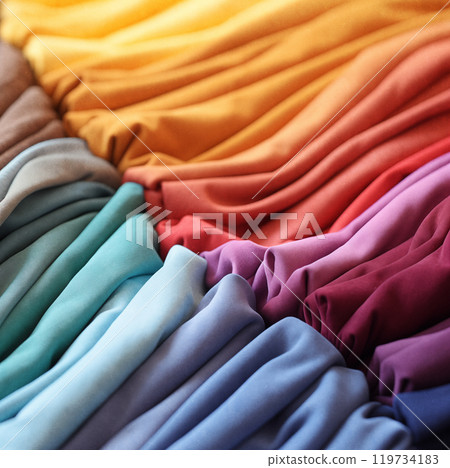 Pile of colorful folded t-shirts. Pile of colorful folded t-shirts. 119734183