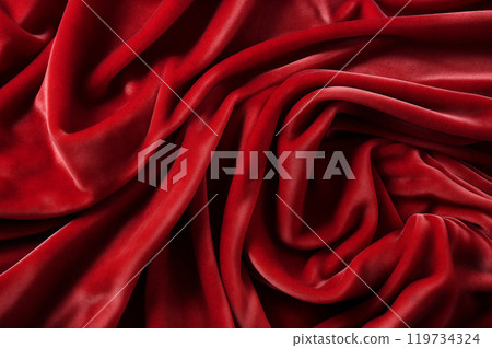 Red luxurious background, the red velvet fabric lies in soft waves. 119734324