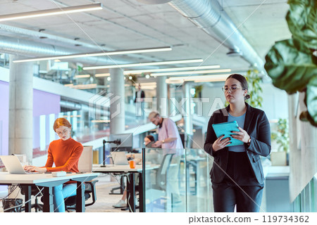 In a modern startup office, a diverse group of young professionals collaboratively tackles various business problems and challenges, surrounded by their engaged colleagues, fostering innovation and 119734362