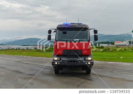 In this captivating scene, a state-of-the-art firetruck, equipped with advanced rescue technology, stands ready with its skilled firefighting team, prepared to intervene and respond rapidly to In this captivating scene, a state-of-the-art firetruck, equipped with advanced rescue technology, stands ready with its skilled firefighting team, prepared to intervene and respond rapidly to 119734533