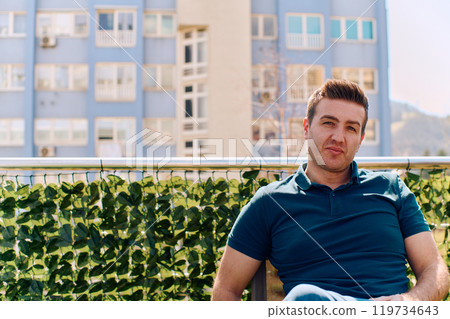 Businessman Relaxing on Terrace with City View 119734643
