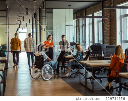 A diverse group of young business individuals congregates in a modern startup coworking center, embodying collaborative innovation and a dynamic atmosphere 119734656