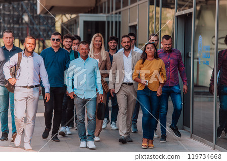 A diverse group of businessmen and colleagues walking together by their workplace, showcasing collaboration and teamwork in the company. A diverse group of businessmen and colleagues walking together by their workplace, showcasing collaboration and teamwork in the company. 119734668