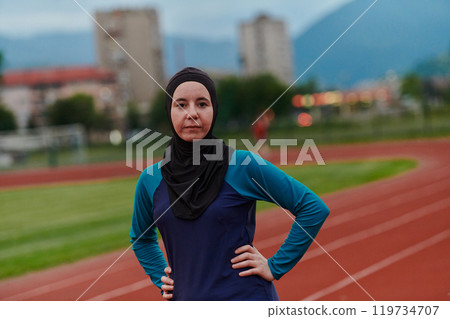 A Muslim woman with a burqa, an Islamic sportswoman resting after a vigorous training session on the marathon course. A hijab woman is preparing for a marathon competition A Muslim woman with a burqa, an Islamic sportswoman resting after a vigorous training session on the marathon course. A hijab woman is preparing for a marathon competition 119734707