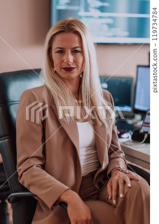A businesswoman sitting in a programmer's office surrounded by computers, showing her expertise and dedication to technology. A businesswoman sitting in a programmer's office surrounded by computers, showing her expertise and dedication to technology. 119734784