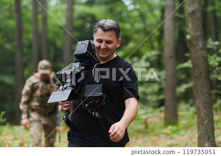 A videographer captures the intensity of a perilous military operation, documenting soldiers in action amidst the dense forest, showcasing the hazardous conditions and tactical maneuvers undertaken by A videographer captures the intensity of a perilous military operation, documenting soldiers in action amidst the dense forest, showcasing the hazardous conditions and tactical maneuvers undertaken by 119735051