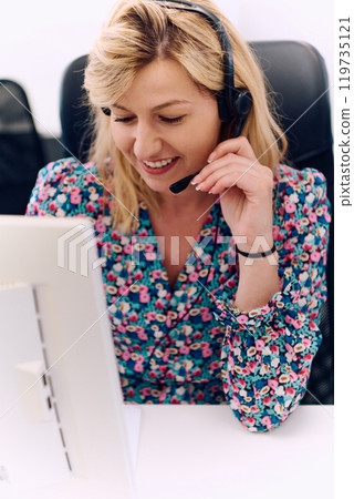 Friendly Call Center Agent Answering Incoming Calls with Headset Providing Remote Customer Service. Friendly Call Center Agent Answering Incoming Calls with Headset Providing Remote Customer Service. 119735121