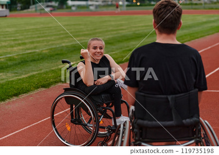 A woman with disability in a wheelchair talking with friend after training on the marathon course A woman with disability in a wheelchair talking with friend after training on the marathon course 119735198