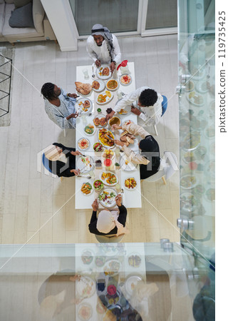 Top view of traditional and diverse Muslim family comes together to share a delicious iftar meal during the sacred month of Ramadan, embodying the essence of familial joy, cultural richness, and Top view of traditional and diverse Muslim family comes together to share a delicious iftar meal during the sacred month of Ramadan, embodying the essence of familial joy, cultural richness, and 119735425