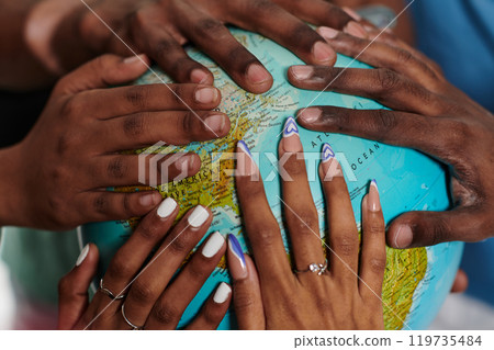 Close up of diverse teenagers' hands delicately exploring a globe, capturing the essence of curiosity and exploration in their tactile engagement with geographical knowledge 119735484