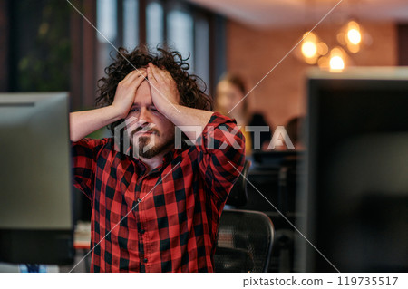 Disappointed Programmer with Messy Hair Looking at Computer Monitor in Office. 119735517