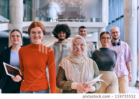 In the sleek corridors of a modern startup office, a diverse group of colleagues, led by their director, confidently stride forward, symbolizing collective success and the journey toward new business 119735532