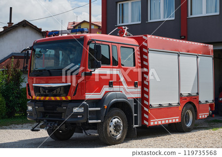 A state-of-the-art firetruck, equipped with advanced rescue technology, stands ready with its skilled firefighting team, prepared to intervene and respond rapidly to emergencies, ensuring the safety A state-of-the-art firetruck, equipped with advanced rescue technology, stands ready with its skilled firefighting team, prepared to intervene and respond rapidly to emergencies, ensuring the safety 119735568