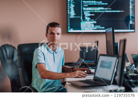 A programmer diligently testing smartphone applications while sitting in their office. 119735576