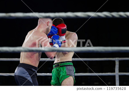 Fierce boxing match showcases athletes' power and skill. 119735628