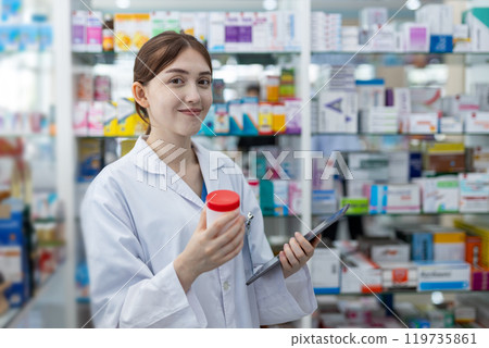woman pharmacists are selecting medications for patients online via tablet in drug store. woman pharmacists are selecting medications for patients online via tablet in drug store. 119735861