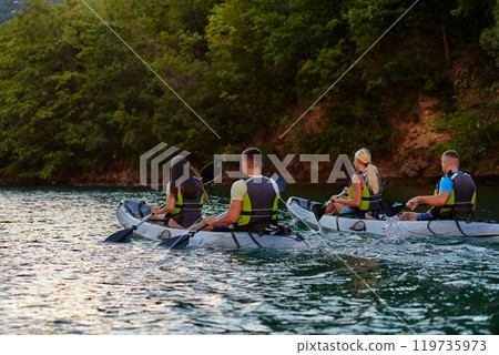 A group of friends enjoying having fun and kayaking while exploring the calm river, surrounding forest and large natural river canyons A group of friends enjoying having fun and kayaking while exploring the calm river, surrounding forest and large natural river canyons 119735973